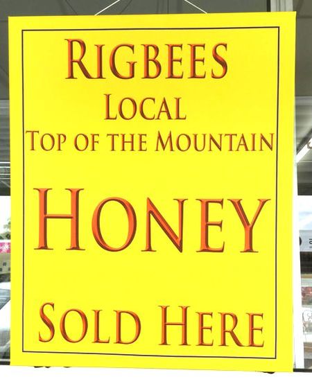 Honey sold here yellow sign